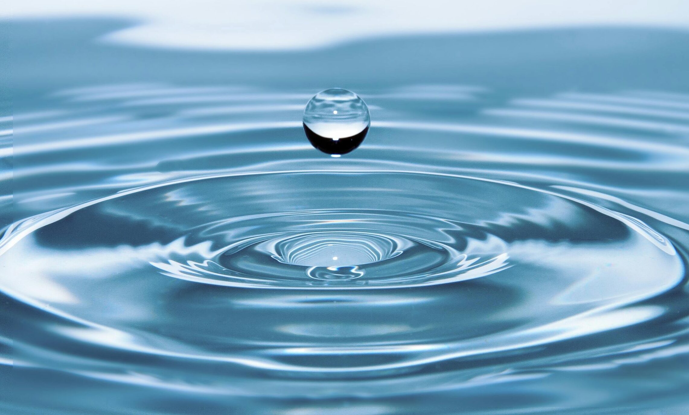 A mesmerizing shot of a water droplet capturing the beauty of liquid dynamics.